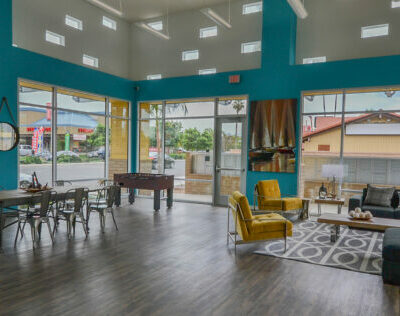 Clubhouse interior with large windows, seating and dining area