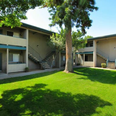 Property building exterior with grassy area and trees