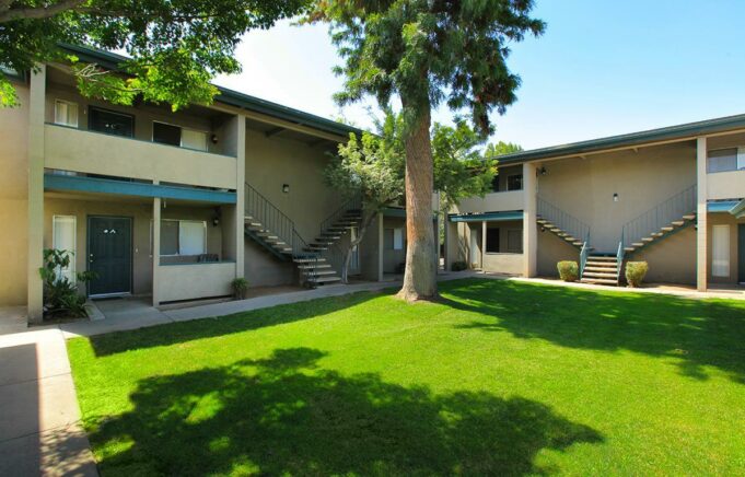 Property building exterior with grassy area and trees